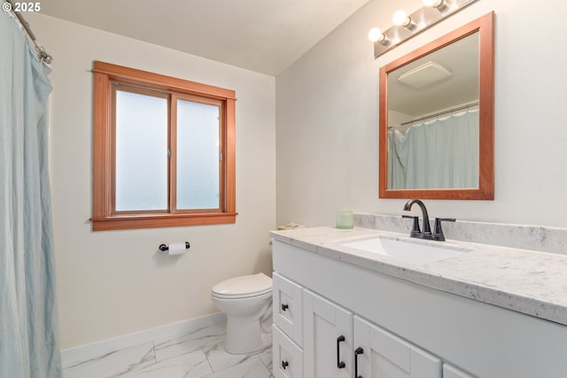 bathroom with vanity, toilet, baseboards, and marble finish floor