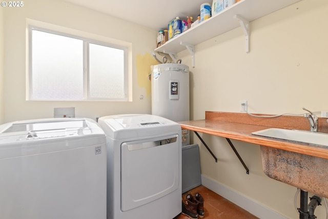 laundry room with washer and dryer, laundry area, baseboards, and electric water heater