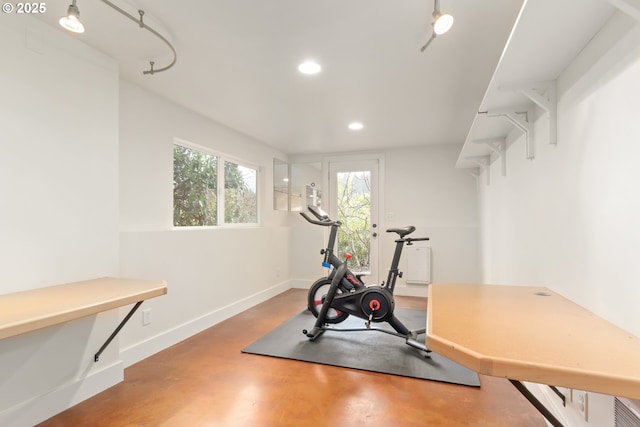 exercise room with recessed lighting and baseboards