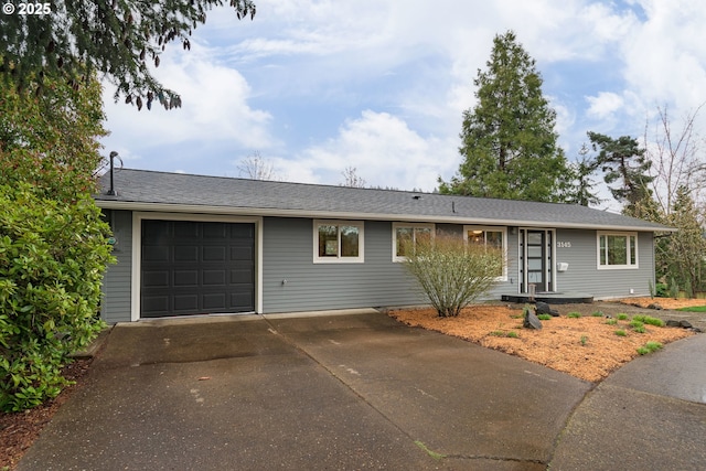 ranch-style house featuring concrete driveway and a garage