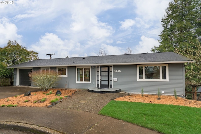 ranch-style home with concrete driveway and a garage