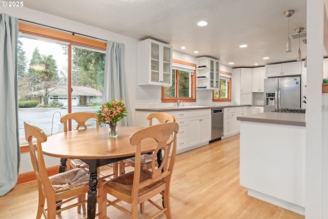 dining area with recessed lighting and light wood finished floors