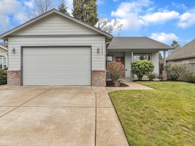 ranch-style home with a garage, a front lawn, concrete driveway, and brick siding