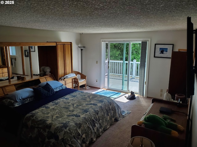 carpeted bedroom with access to outside and a textured ceiling