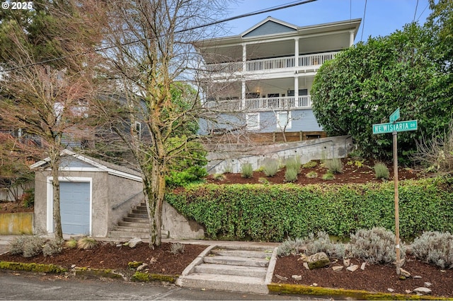 exterior space featuring a garage, an outbuilding, and stucco siding