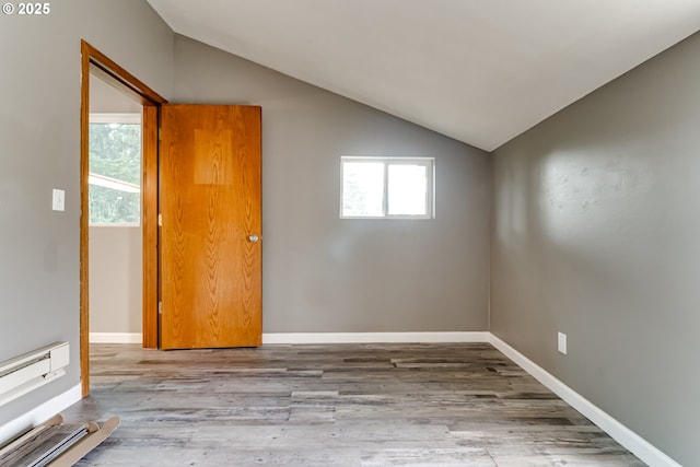 unfurnished room with vaulted ceiling and hardwood / wood-style floors