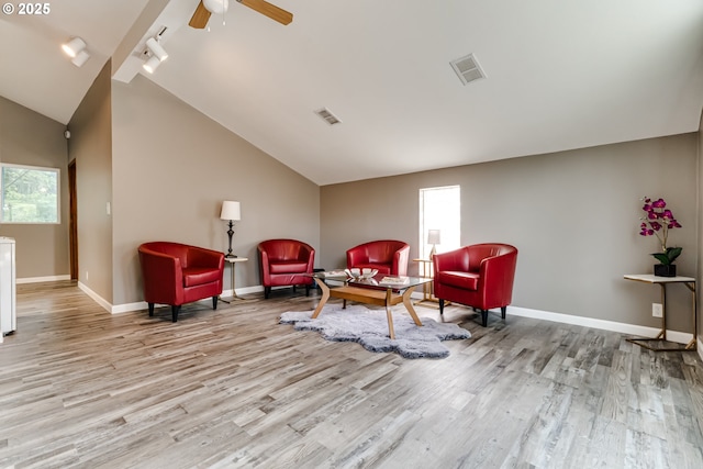 sitting room featuring light wood-type flooring, ceiling fan, rail lighting, and vaulted ceiling