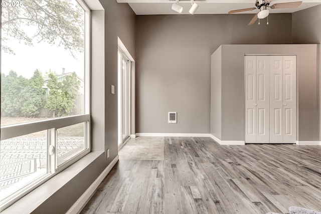 unfurnished room with ceiling fan and light wood-type flooring