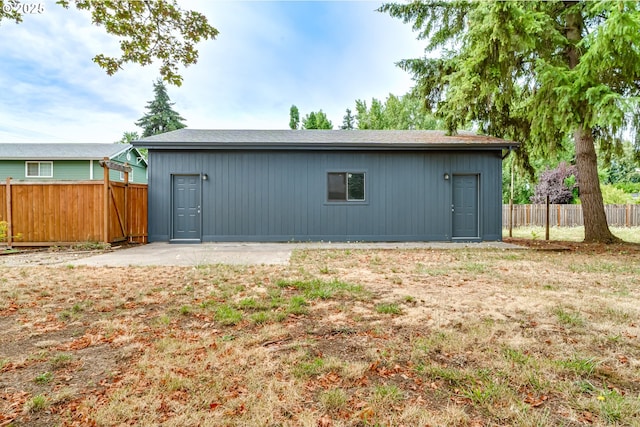 view of outbuilding featuring a lawn