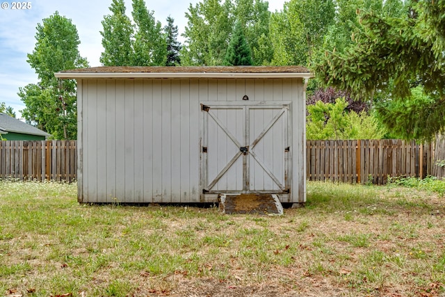 view of outbuilding featuring a lawn