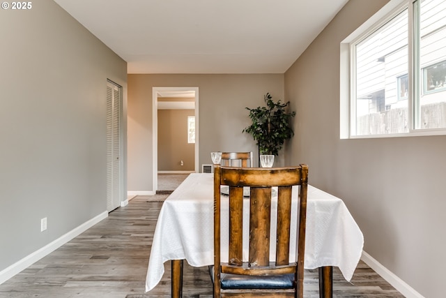 dining area featuring a healthy amount of sunlight and hardwood / wood-style floors