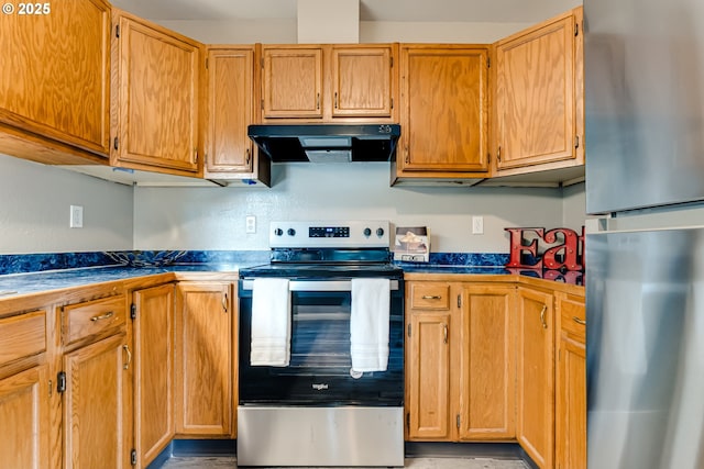 kitchen with exhaust hood and appliances with stainless steel finishes