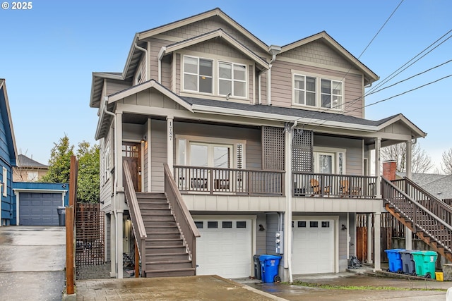 view of front of property with a garage, covered porch, stairway, and board and batten siding