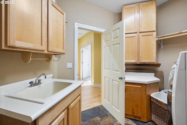 15111 Oyer Dr, Oregon City, OR 97045 - laundry area with cabinet space and dark stone finish flooring