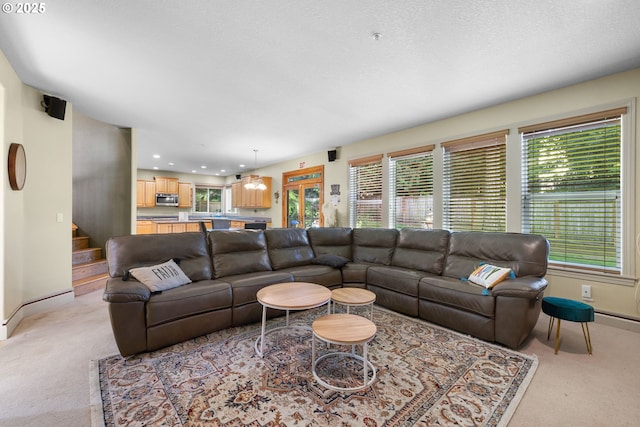 15111 Oyer Dr, Oregon City, OR 97045 - living room with light carpet, plenty of natural light, baseboards, stairway, and recessed lighting