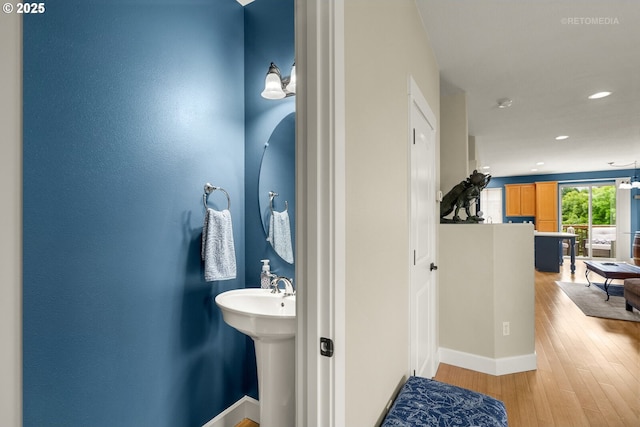 1902 NE 48th Way, Hillsboro, OR 97124 - bathroom featuring wood finished floors, recessed lighting, baseboards, and a sink