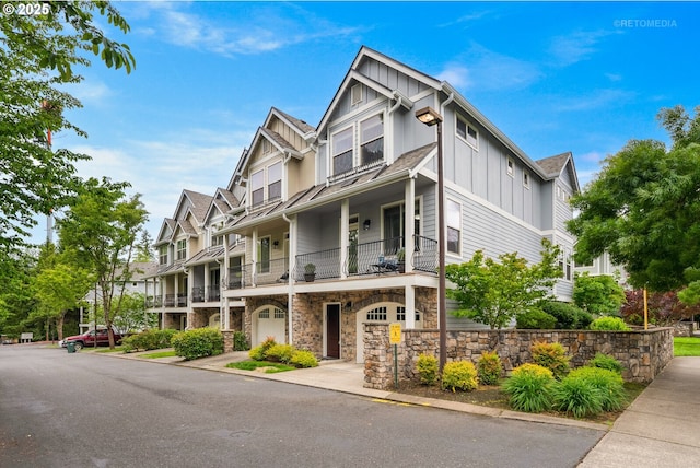 1902 NE 48th Way, Hillsboro, OR 97124 - view of front of house with board and batten siding, a balcony, and stone siding