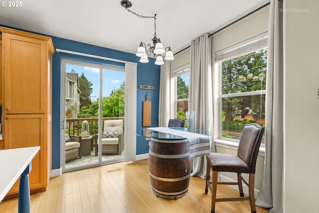 1902 NE 48th Way, Hillsboro, OR 97124 - dining room with a chandelier, light wood-style floors, and baseboards