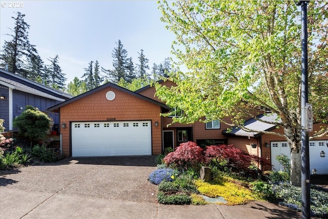 ranch-style home featuring a garage and concrete driveway