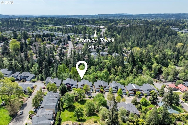 drone / aerial view with a residential view and a wooded view