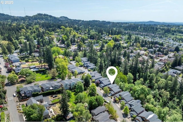 birds eye view of property with a forest view and a residential view