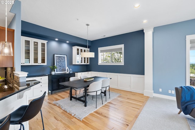 3646 SW Baird St Unit 3, Portland, OR 97219 - dining space with light wood-style flooring, recessed lighting, decorative columns, and wainscoting