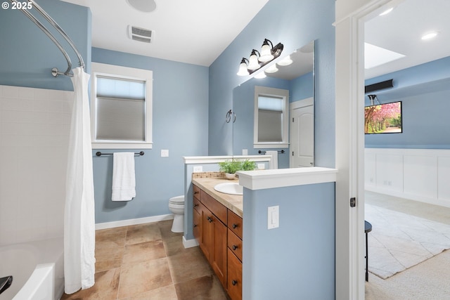3646 SW Baird St Unit 3, Portland, OR 97219 - bathroom featuring vanity, toilet, and shower / bath combination with curtain