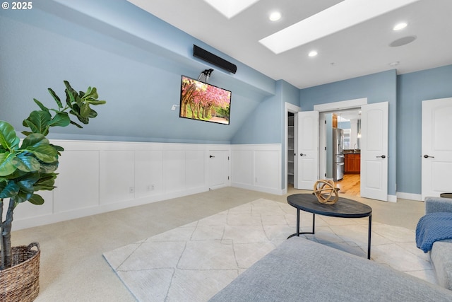 3646 SW Baird St Unit 3, Portland, OR 97219 - living area featuring a skylight, wainscoting, a decorative wall, light carpet, and recessed lighting