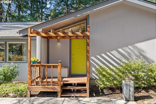 view of exterior entry with a deck