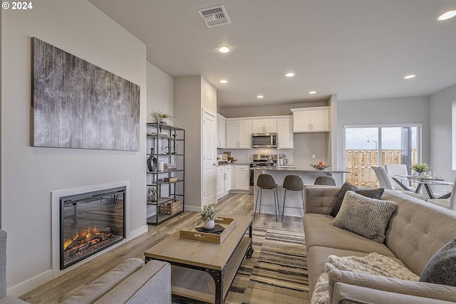 3619 Chestnut St Lot 51, Forest Grove, OR 97116 - living room with light wood-type flooring, recessed lighting, baseboards, and a glass covered fireplace