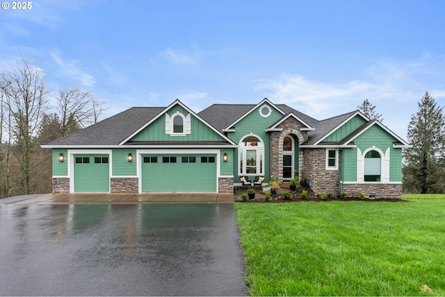 craftsman inspired home featuring a front yard, an attached garage, stone siding, board and batten siding, and driveway
