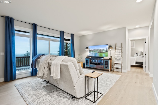 living area with wood finished floors, baseboards, and recessed lighting