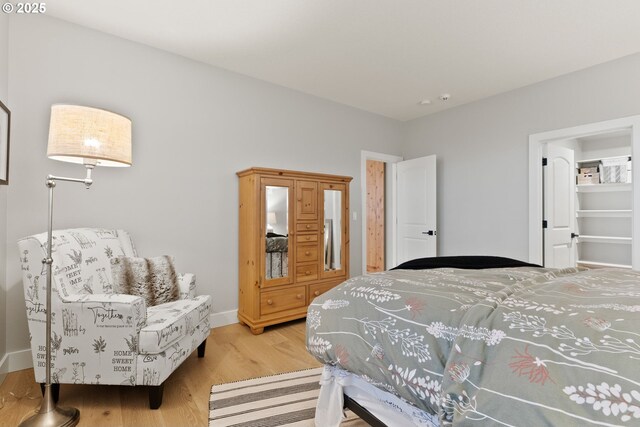 bedroom with baseboards and wood finished floors