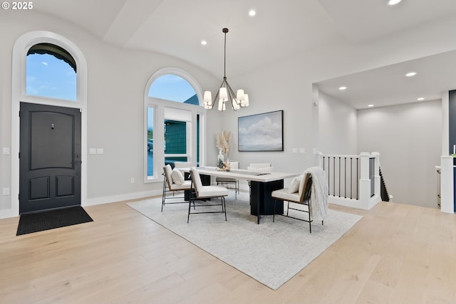 dining space with light wood-type flooring, a notable chandelier, and recessed lighting