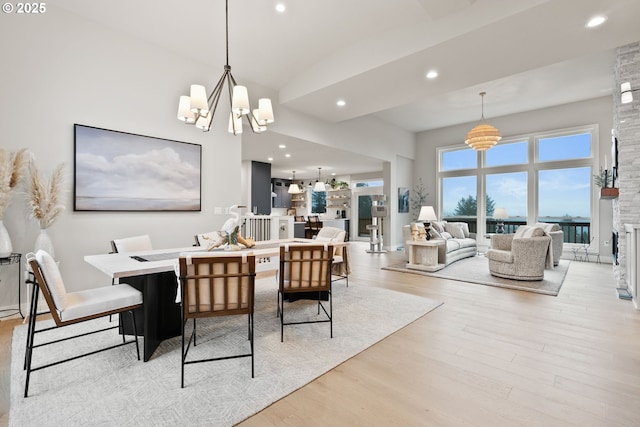 dining space with light wood-style flooring, a chandelier, and recessed lighting