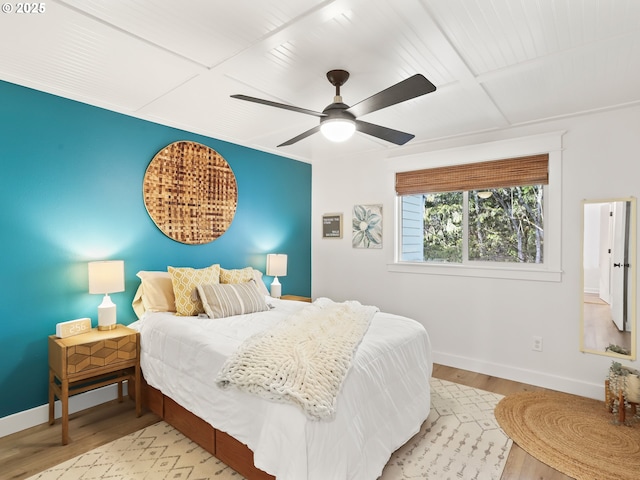 bedroom featuring coffered ceiling, light hardwood / wood-style flooring, and ceiling fan