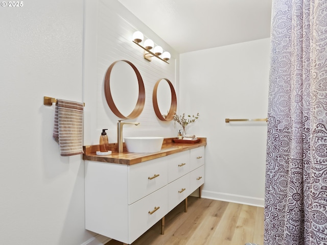 bathroom featuring hardwood / wood-style flooring and vanity