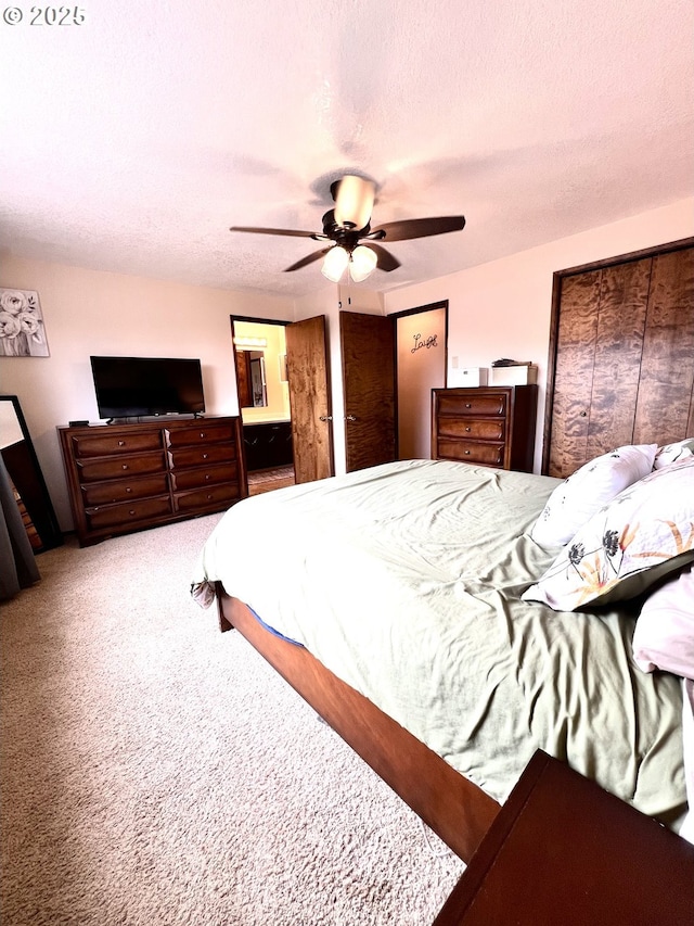 carpeted bedroom with ceiling fan and a textured ceiling