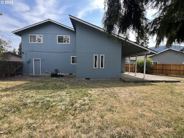 back of property with a patio area, a lawn, and fence private yard