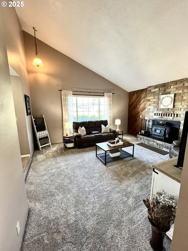 living area featuring an accent wall, wood walls, carpet floors, a textured ceiling, and high vaulted ceiling