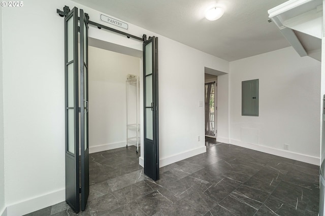 20256 S Swank Rd, Colton, OR 97017 - unfurnished room with electric panel, a barn door, baseboards, and marble finish floor