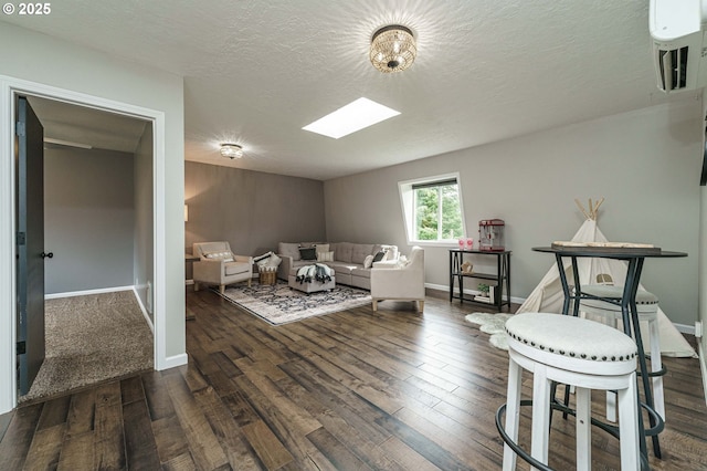 20256 S Swank Rd, Colton, OR 97017 - living area with a textured ceiling, baseboards, dark wood-style flooring, and a skylight