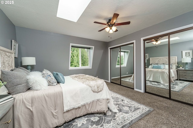 20256 S Swank Rd, Colton, OR 97017 - carpeted bedroom featuring two closets, baseboards, a skylight, and ceiling fan