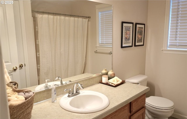 full bath featuring toilet, curtained shower, and vanity