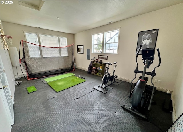 workout room featuring golf simulator, electric panel, visible vents, and baseboards