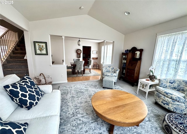 living room with lofted ceiling and stairs