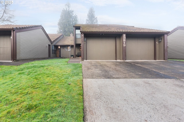 view of front of home with a front yard and a garage