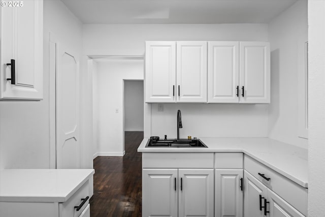 461 Blair Blvd, Eugene, OR 97402 - kitchen featuring a sink, white cabinetry, dark wood-style flooring, and light countertops