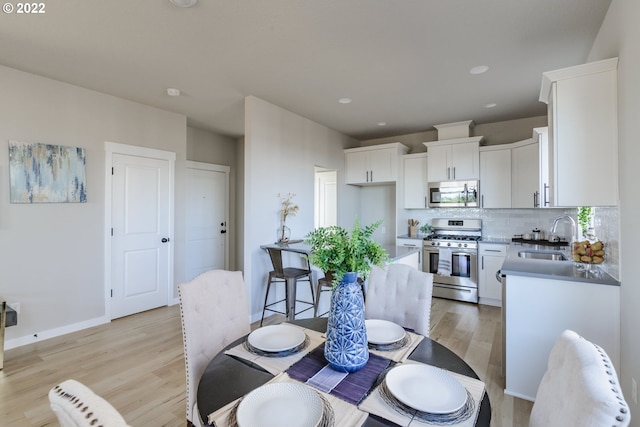 dining space featuring light hardwood / wood-style floors and sink