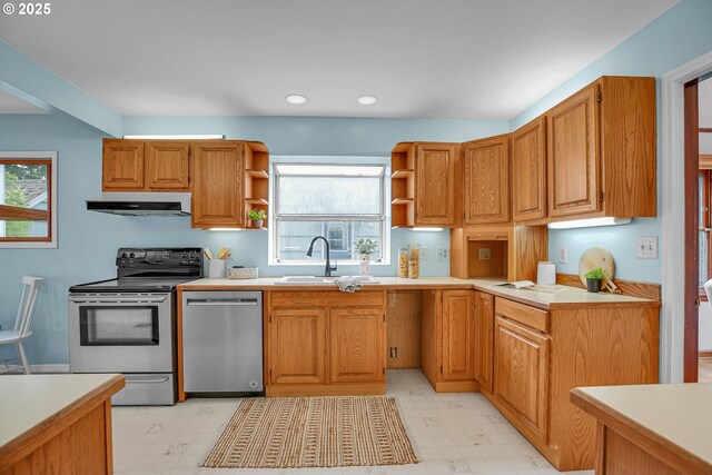 kitchen featuring appliances with stainless steel finishes, a sink, under cabinet range hood, open shelves, and light flooring